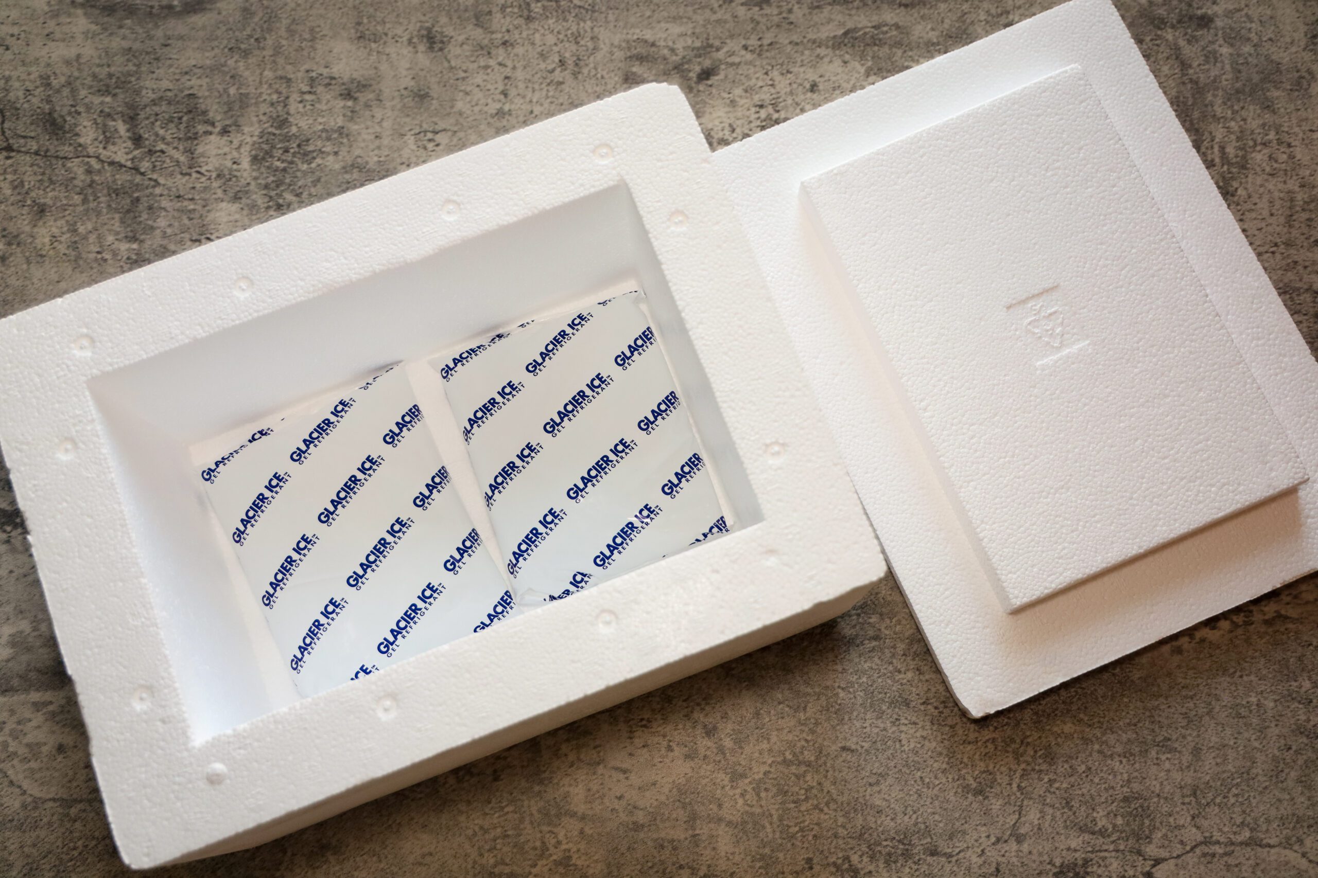 San Diego, CA USA on September 1, 2022. A Styrofoam cooler with lid and ice gel packs for shipping perishable food or medication. Cold packing material.