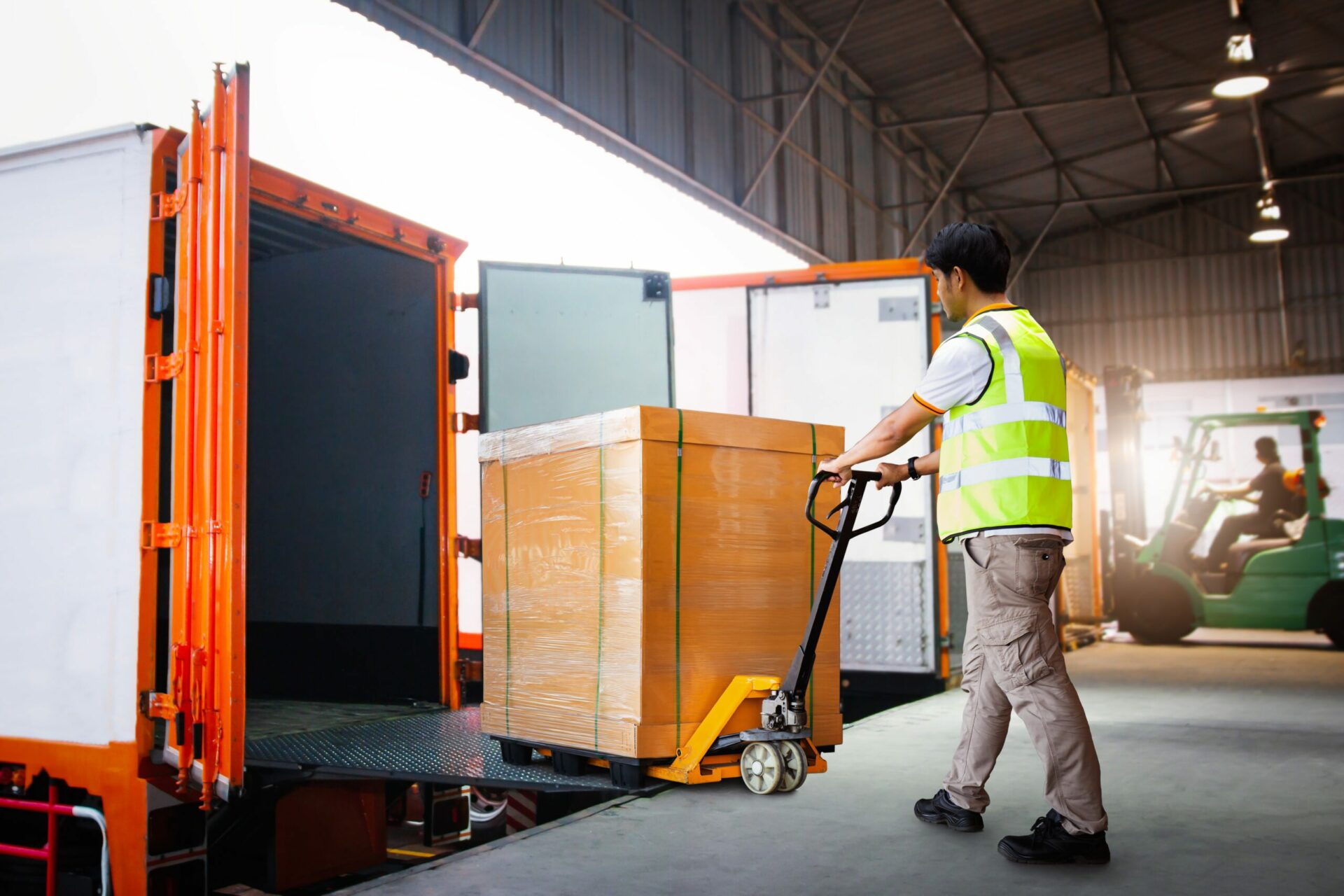 Workers Unloading Heavy Box into Container Truck. Trucks Loading Dock Warehouse. Supply Chain, Package Boxes Shipment, Supplies Warehouse. Freight Truck Logistic, Cargo Transport, Warehouse Shipping.