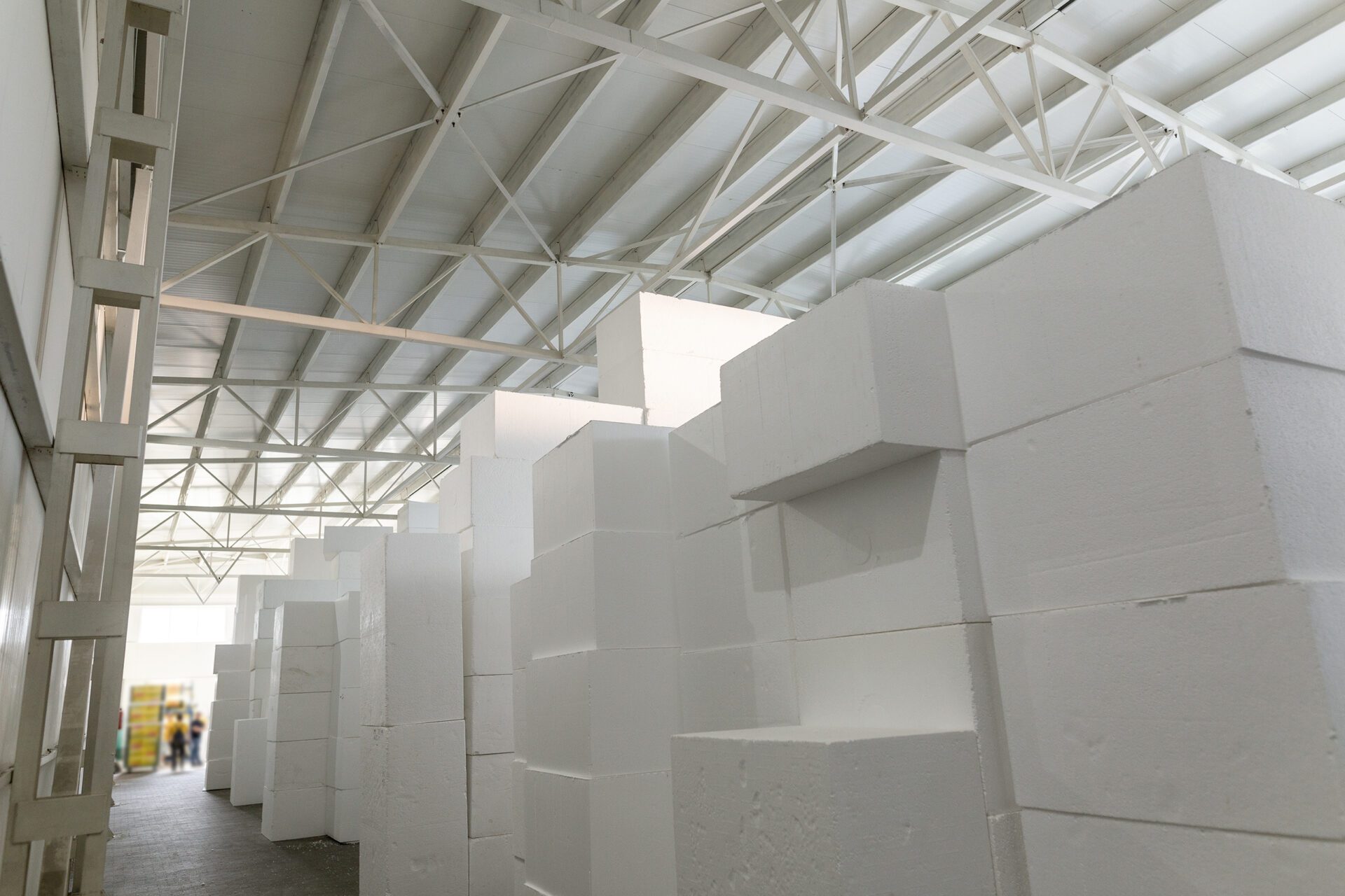 Industrial production of expanded polystyrene. A large blocks of Styrofoam are stacked in a warehouse. Building materials.