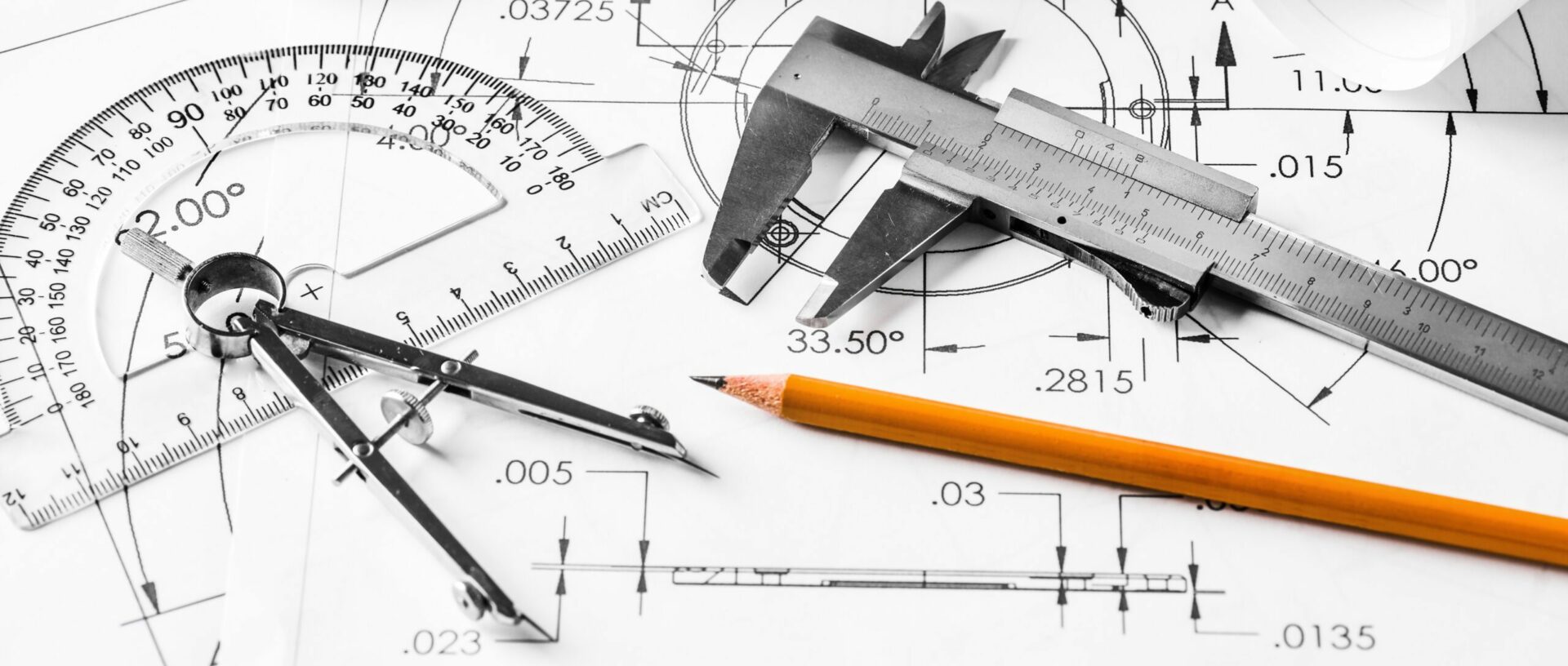 Engineer technicial drawings and mechanical parts engineering industry work project paper prints. Measuring tools on table.